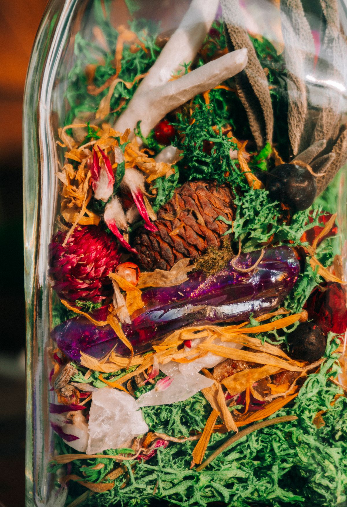 Glass jar filled with dried botanicals