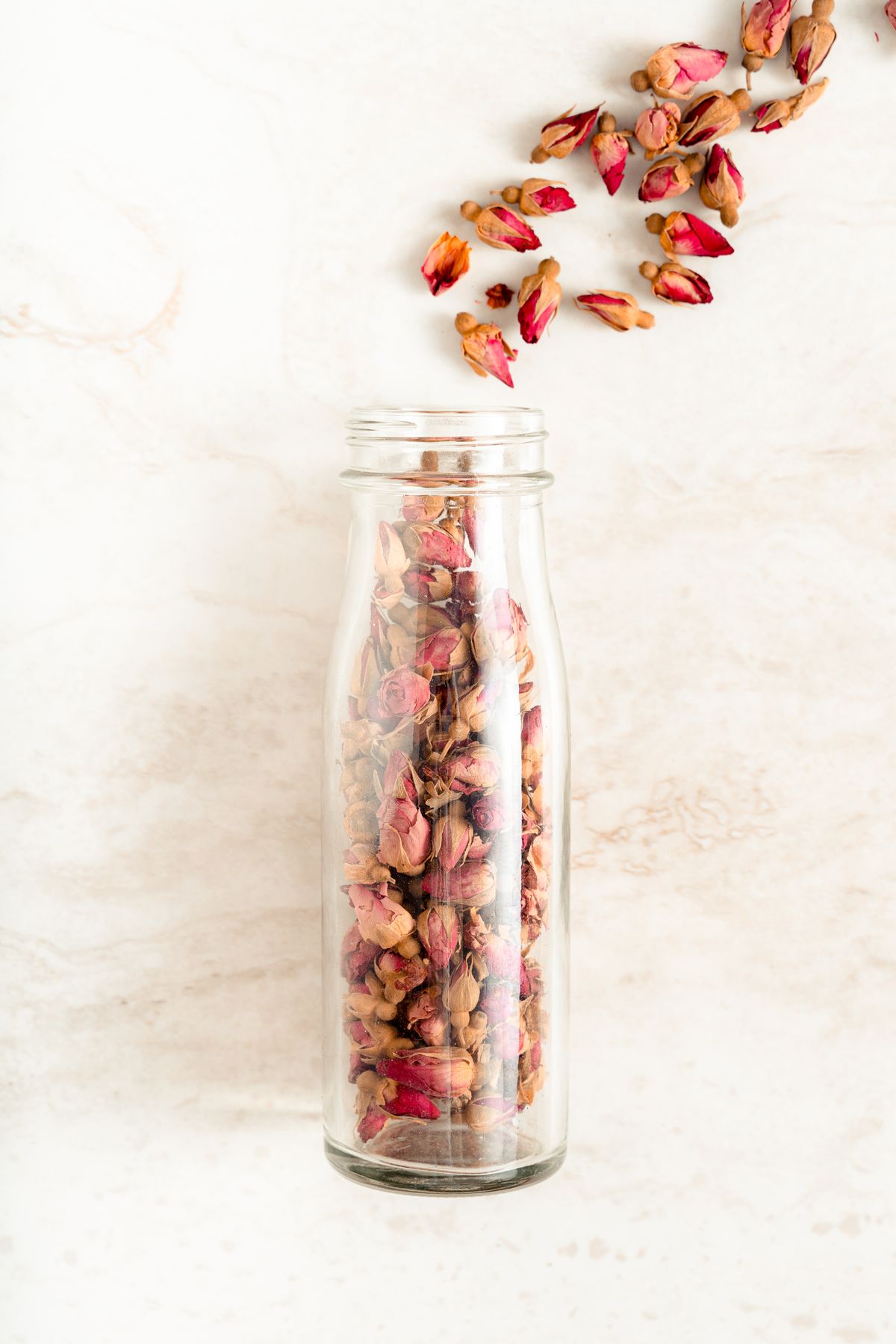 Glass jar with dried rose buds